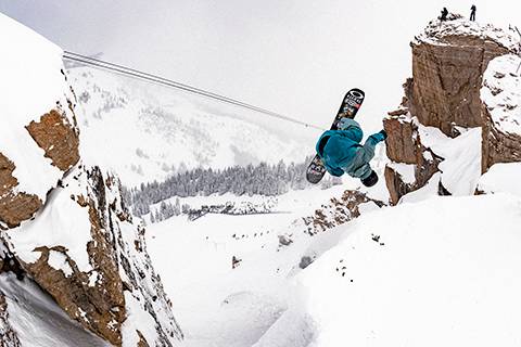 Snowboarder flipping into Corbet's Couloir at Jackson Hole Mountain Resort