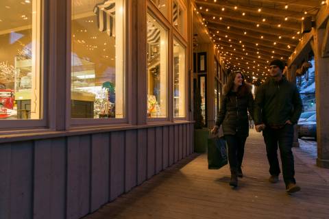 2 people walking by a shop on Jackson Town Square in Jackson Hole Wyoming